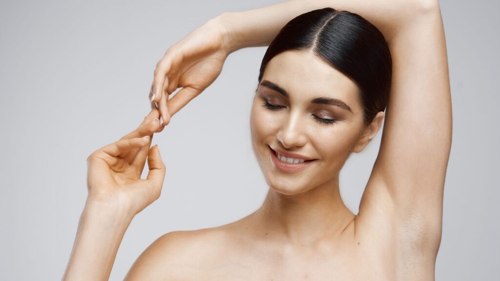 Woman applying cream on her face
